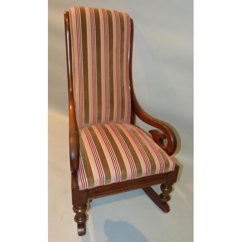 652 - A Victorian Mahogany Rocking Chair having striped overstuffed seat and back with scroll arms  