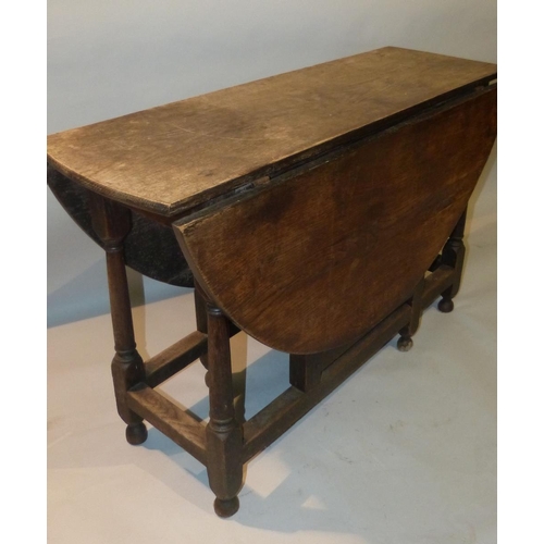 654 - An 18th Century Oak Gate Leg Table having single drawer on round turned legs, 1m 30cm x 1m 16cm  