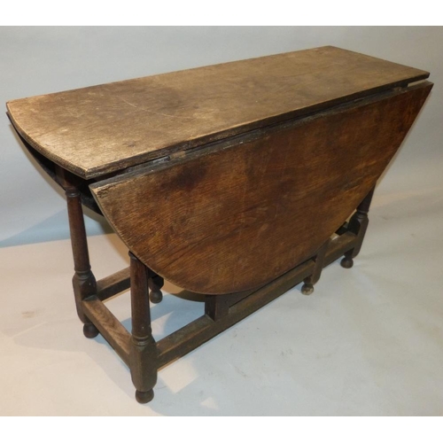 654 - An 18th Century Oak Gate Leg Table having single drawer on round turned legs, 1m 30cm x 1m 16cm  