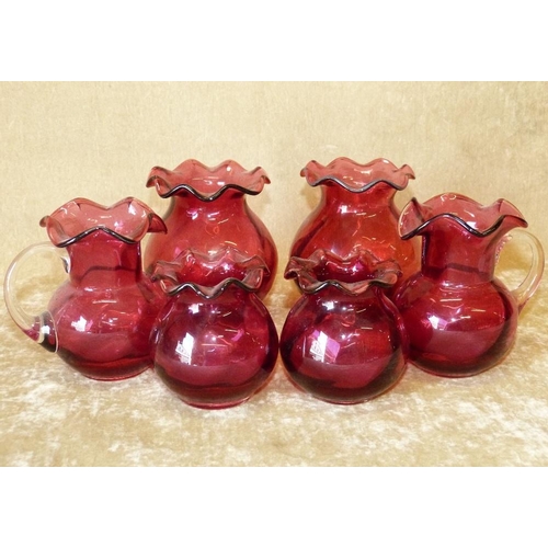 66 - A Pair of Cranberry Glass Round Bulbous Trumpet Shaped Vases having crinkle rims, 11.5cm high, a pai... 