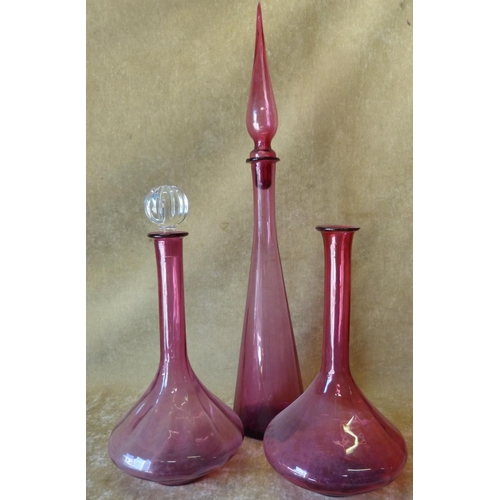 80 - A Pair of Cranberry Glass Bulbous Thin Neck Decanters (1 with stopper) 39cm high, also another talle... 