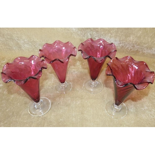 83 - A Set of 4 Cranberry Glass Round Trumpet Shape Vases having crinkled rims on clear round bases, 18cm... 