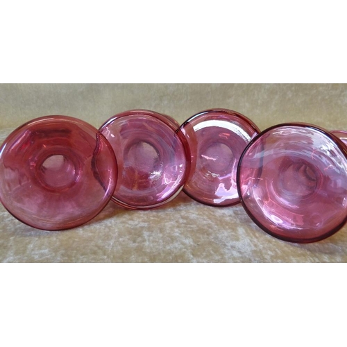 89 - A Pair of Ruby Glass Candlesticks on sweeping bases, 12cm high, also a smaller pair of Ruby glass ca... 