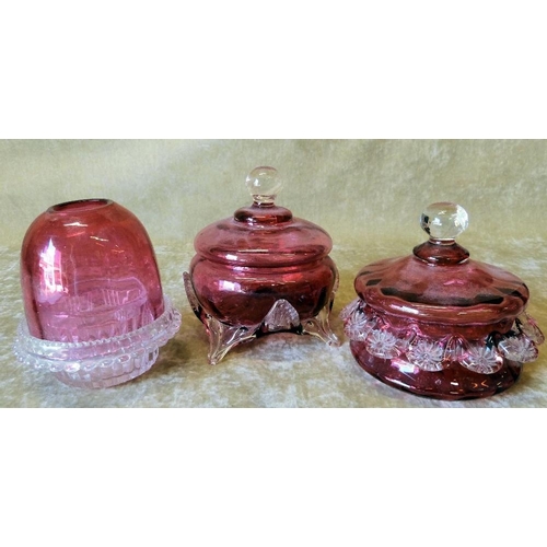 90 - A Ruby Glass and Clear Glass Storm Candlesticks, 11cm high, also 2 Cranberry glass bulbous lidded po... 