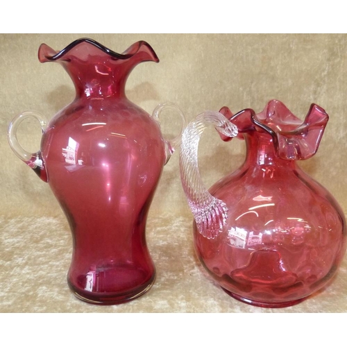 93 - A Cranberry Glass Bulbous Jug having crinkled rim with twist clear handle, 17cm high, also a Cranber... 