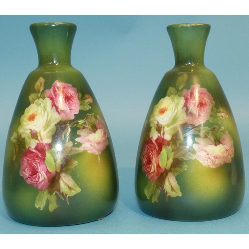 13 - A Pair China Bulbous Thin Neck Vases on green ground with multicoloured rose decoration, 13cm high