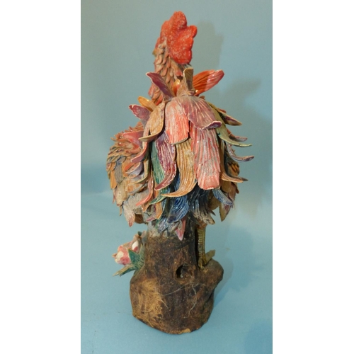 27 - An Oriental Earthenware Figure of a Cockerel having all over raised encrusted decoration, 40cm high