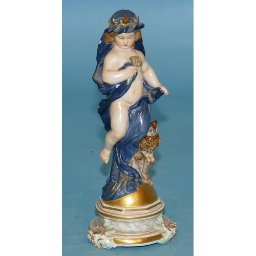 118 - A Meissen Figure of a young cupid draped in a blue cloth with crown standing next to an owl, on glob... 