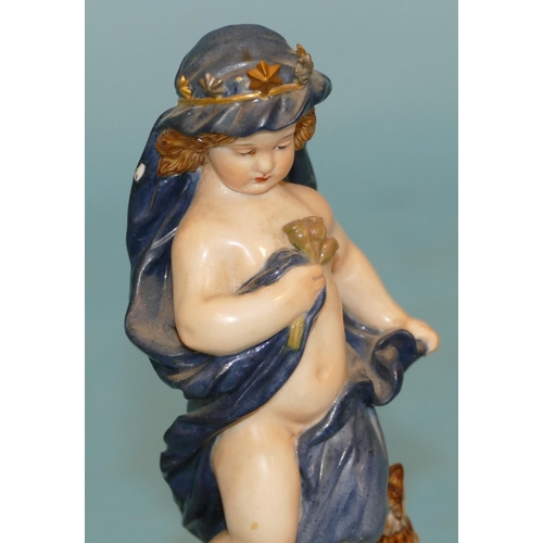 118 - A Meissen Figure of a young cupid draped in a blue cloth with crown standing next to an owl, on glob... 