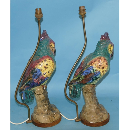 51 - A Pair of Majolica Table Lamps inform of perched parrots on multicoloured ground 50cm high over all.