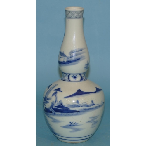 73 - An Oriental Blue and White Round Bulbous Gould Vase having fisherman, river landscape and building d... 