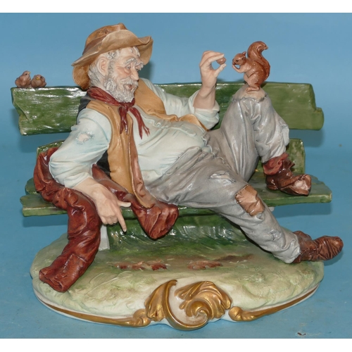 84 - A Capo Di Monte Figure of a drunken gentleman sprawled on a bench with squirrel on his knee, 26cm wi... 