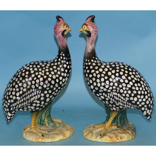 94 - A Pair of Italian China Figures of Birds on black ground having white spotted decoration (1 neck res... 