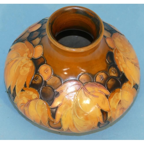 121 - A Moorcroft Small Round Bulbous Thin Necked Vase on brown ground with multicoloured fruit and leaf d... 