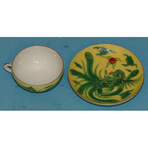 157 - An Oriental Miniature Cup and Saucer on yellow and green ground having phoenix and dragon decoration... 