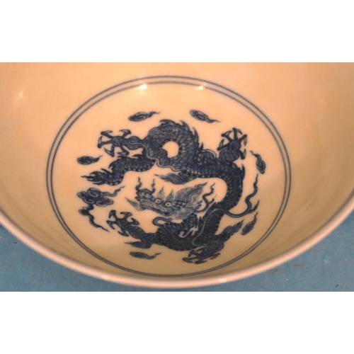 47 - An Oriental Blue and White Round Trumpet Shaped Small Bowl having dragon decoration, 15.5cm diameter... 