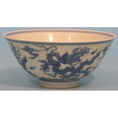 47 - An Oriental Blue and White Round Trumpet Shaped Small Bowl having dragon decoration, 15.5cm diameter... 