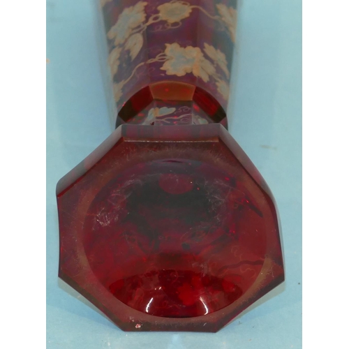 74 - A Ruby Glass Octagonal Trumpet Shaped Vase having raised vine and leaf decoration (rim of base polis... 