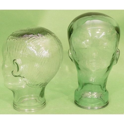 118 - A Glass Bust of a head 28cm high and another similar smaller bust, 23.5cm high (2).