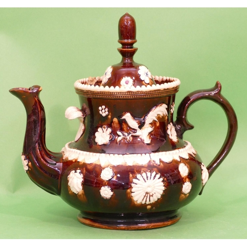 16 - A 19th Century Glazed Earthenware Round Bulbous Shaped Barge Teapot having raised bird, floral and s... 