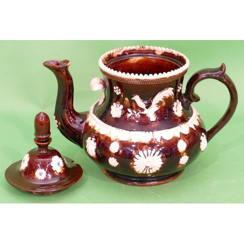 16 - A 19th Century Glazed Earthenware Round Bulbous Shaped Barge Teapot having raised bird, floral and s... 