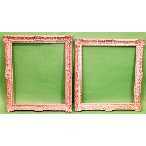 165 - 2 x White and Gilt Painted Picture Frames having raised, floral and shell decoration, inner measurem... 