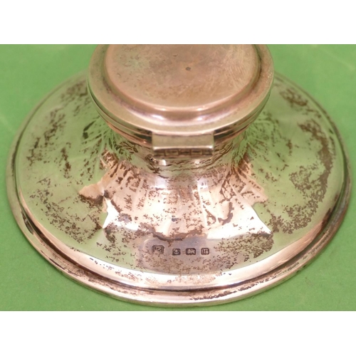 219 - A Birmingham Silver Round Inkwell having hinge lid with sweeping base (base dented) 10.5cm diameter.