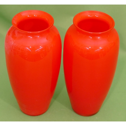 23 - A Pair of Red Glass Round Bulbous Thin Necked trumpet Shaped Vases, 27cm high.