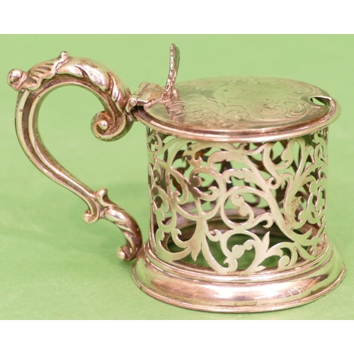 254 - A Victorian Silver Round Mustard Pot having hinge lid, scroll handle and pierced decoration, London ... 