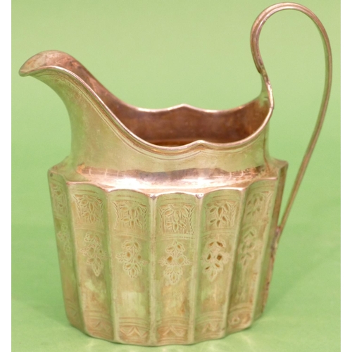 259 - An Irish Silver Oval Milk Jug having all over flute and engraved decoration (handle and rim to base ... 