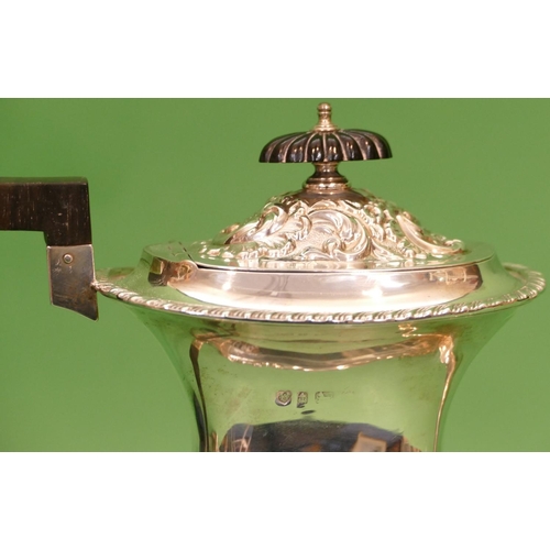 294 - An Edward VII Rectangular Bulbous Silver Teapot having part embossed flora, leaf and scroll decorati... 