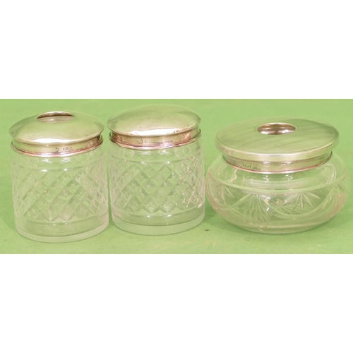 357 - A Pair of Cut Glass Round Dressing Table Pots having London silver tops, also another cut glass dres... 