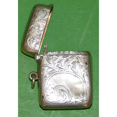 394 - An Edward VII Silver Vesta Case having all over chased, floral and scroll decoration, hinge lid, Bir... 