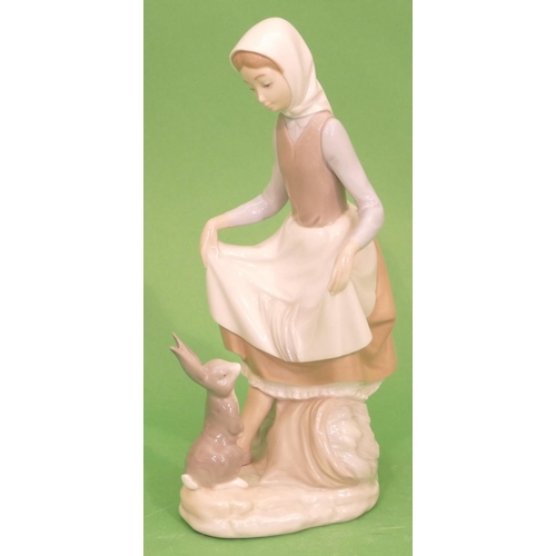 44 - A Lladro Group of a young lady with rabbit at her feet, 23cm high.