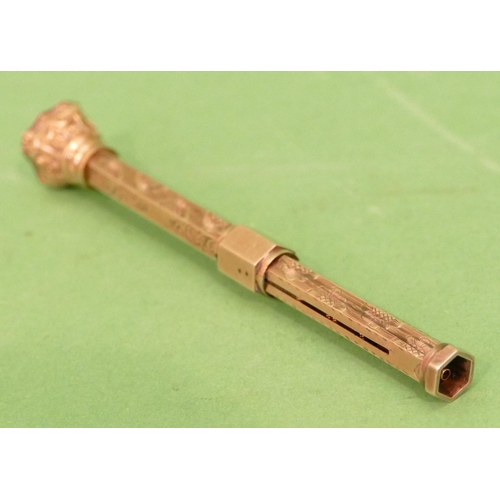 449 - A Gold Hexagonal Slide Action Propelling Pencil having engraved floral and scroll decoration, shaped... 