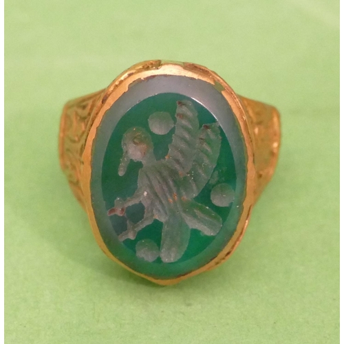 457 - A Roman Style Ring having oval green stone with bird motif, size P/Q.