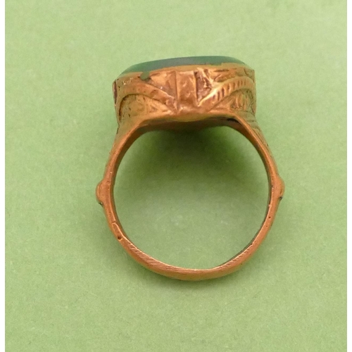 457 - A Roman Style Ring having oval green stone with bird motif, size P/Q.