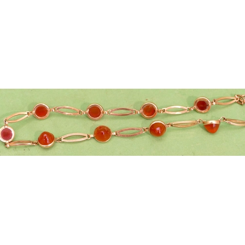 479 - A 9ct Gold Necklace mounted with 10 red carbuncle stones (clasp in need of restoration) 18.1g gross ... 