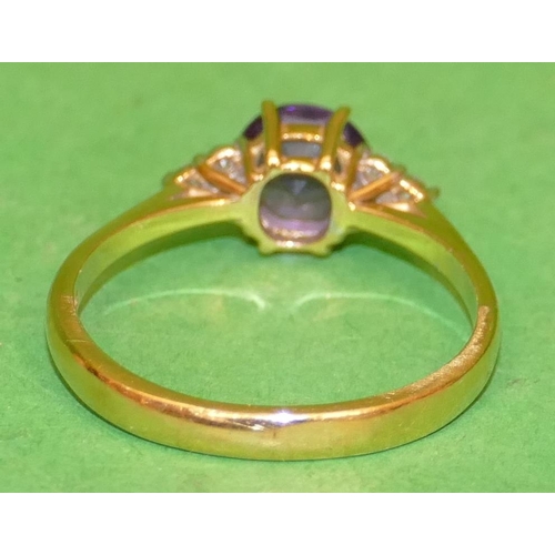 487 - An 18ct Gold Ladies Ring set with centre amethyst flanked by 6 small diamonds, size Q.