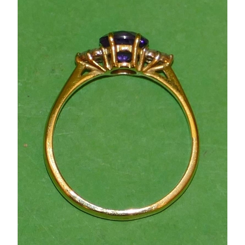 487 - An 18ct Gold Ladies Ring set with centre amethyst flanked by 6 small diamonds, size Q.