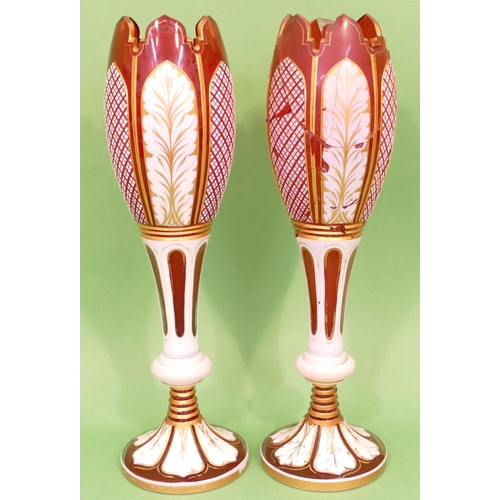 51 - A Pair of Bohemian Ruby Glass and Enamelled round Bulbous Vases having crinkled rims, raised cut and... 