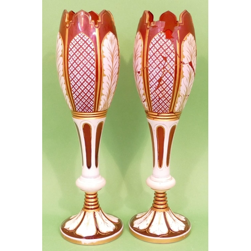 51 - A Pair of Bohemian Ruby Glass and Enamelled round Bulbous Vases having crinkled rims, raised cut and... 