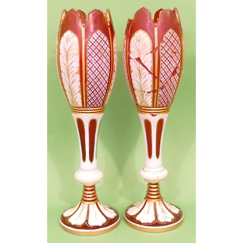 51 - A Pair of Bohemian Ruby Glass and Enamelled round Bulbous Vases having crinkled rims, raised cut and... 