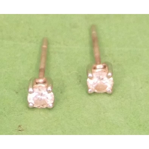 517 - A Pair of Small Solitaire Diamond Earrings, approximately 0.150ct.