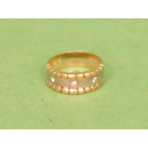 527 - An 18ct 2 Coloured Gold Ring set with 3 small diamonds, size O/P, 6.8g gross.