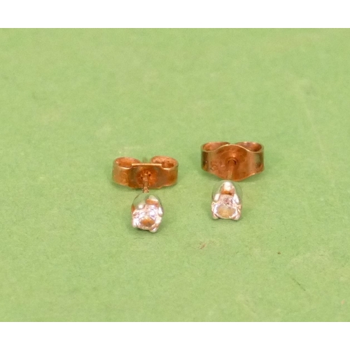 554 - A Pair of Small 9ct Gold Solitaire Diamond Earrings, approximately 0.10ct each.