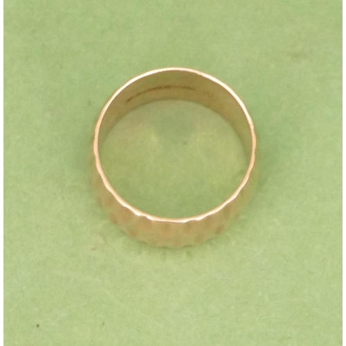 577 - A 9ct Gold Wide Band Wedding Ring having chased decoration, size N, 7.4g.