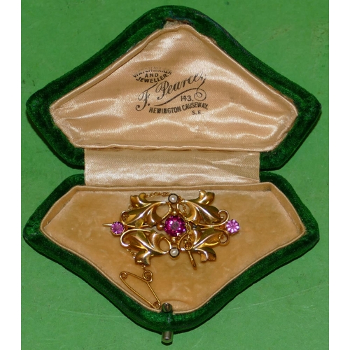 616 - A 9ct Gold Scallop Shaped Brooch having raised leaf decoration, mounted with 3 pink stones and half ... 