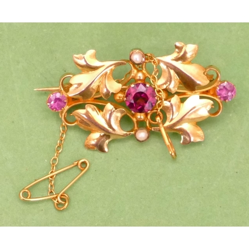 616 - A 9ct Gold Scallop Shaped Brooch having raised leaf decoration, mounted with 3 pink stones and half ... 