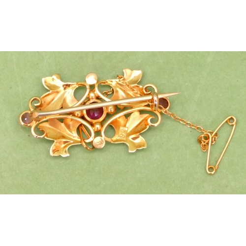 616 - A 9ct Gold Scallop Shaped Brooch having raised leaf decoration, mounted with 3 pink stones and half ... 